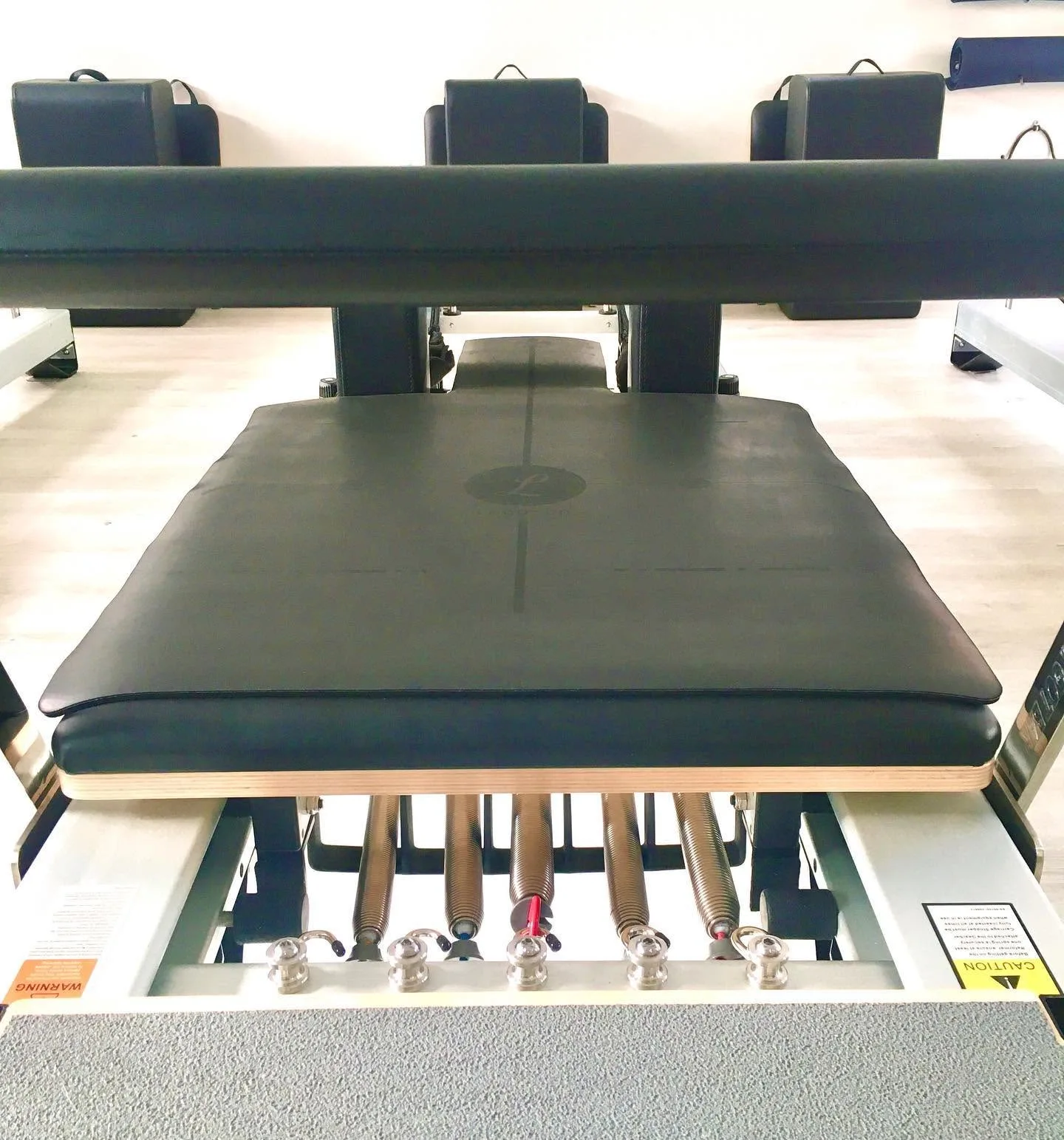 Front-on reformer carriage detail, spring bank exposed, headrests visible
